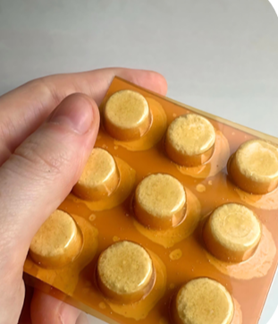 A person is holding a blister pack of pills in their hand.