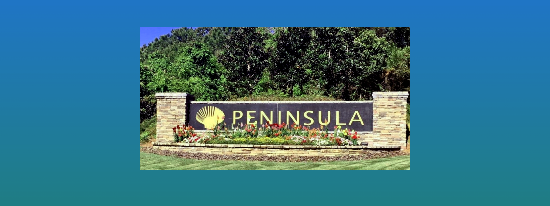 The entrance sign with trees in the background located at The Peninsula, Gulf Shores AL