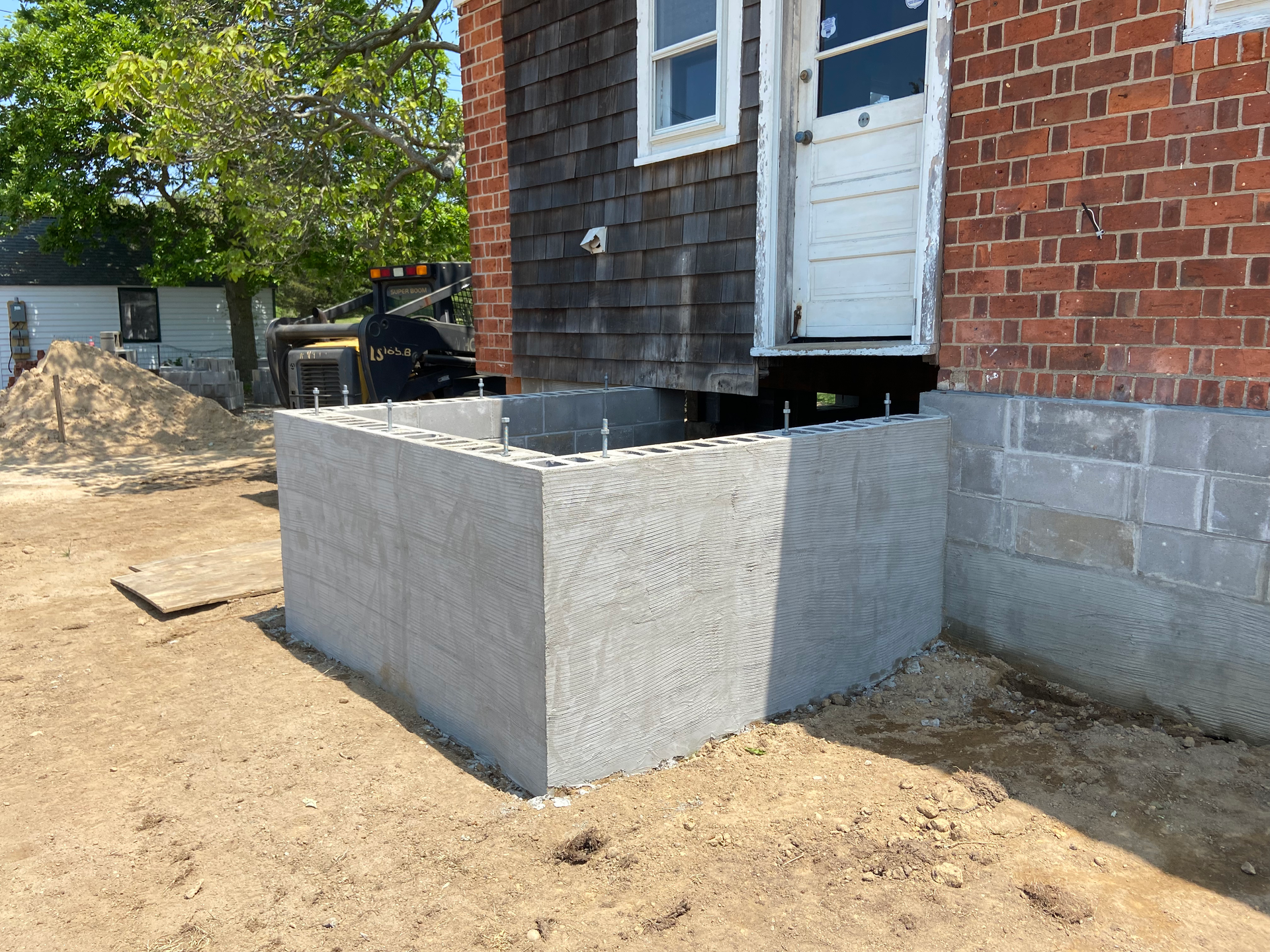 A brick building with a concrete block in front of it.