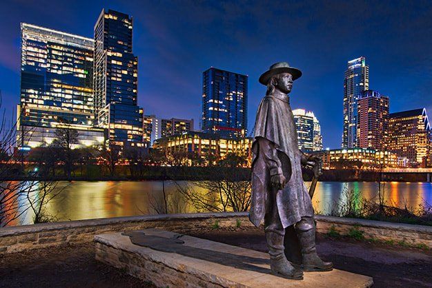 statue of stevie ray vaughan and austin skyline