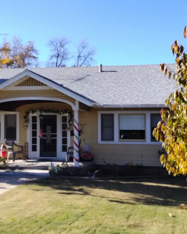 A house with a christmas wreath on the porch