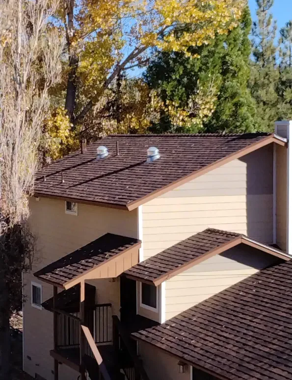 An aerial view of a house with a brown roof