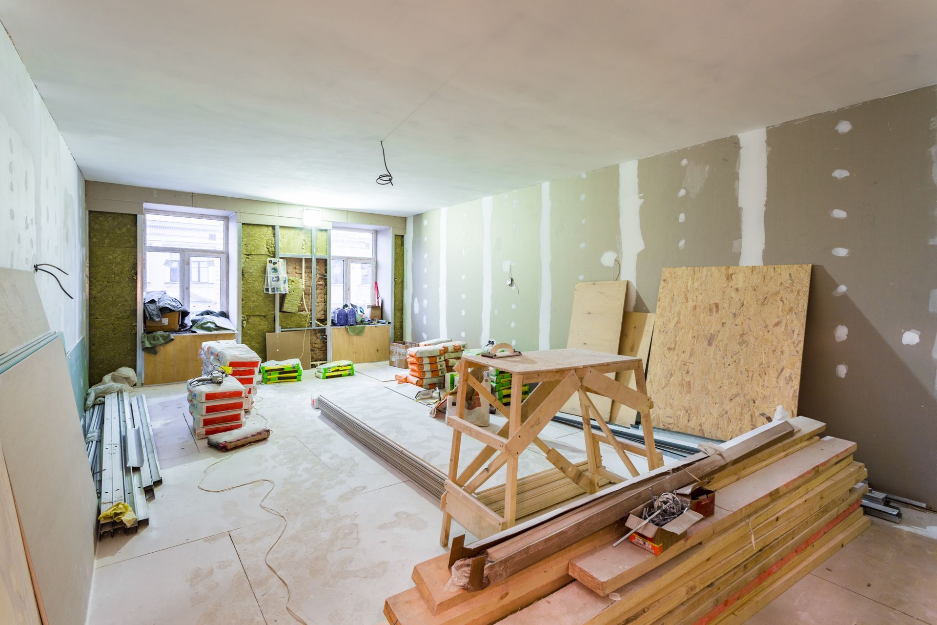 A room that is being remodeled with a lot of wood and tools.