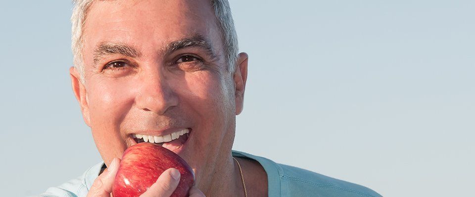 a man biting an apple