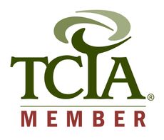 TCA member logo: A circular emblem featuring the initials 
