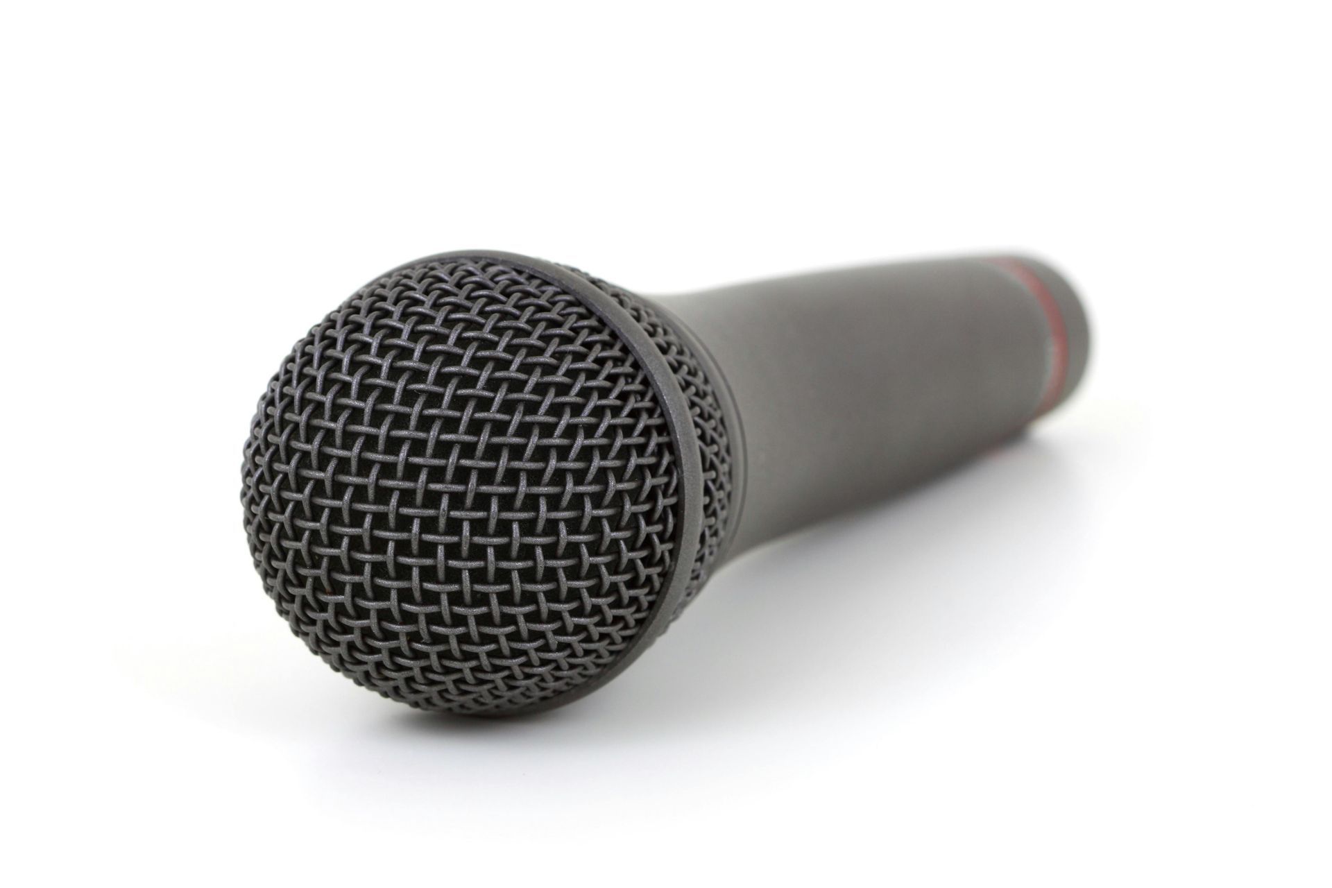 A close up of a microphone on a white background.