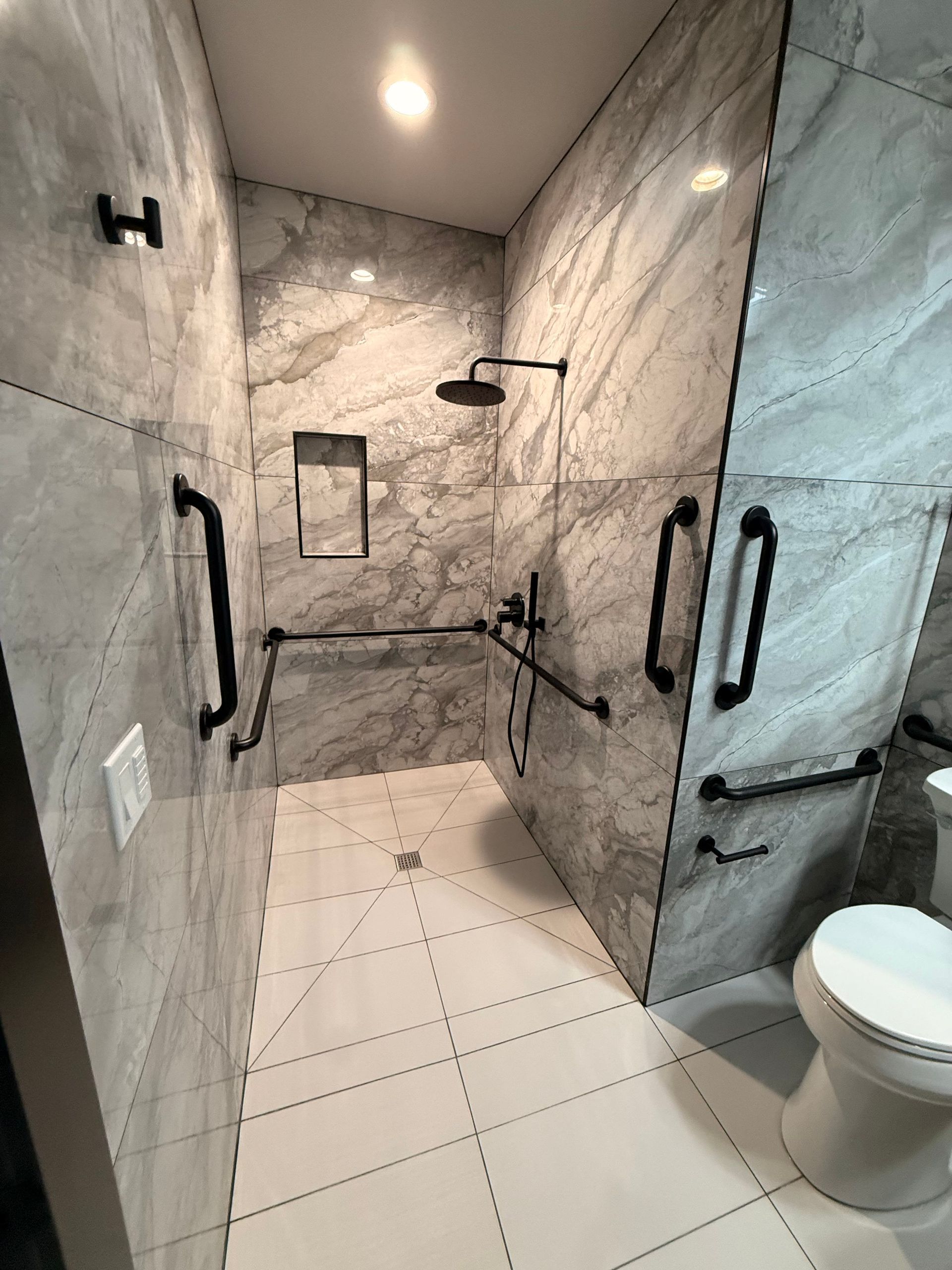 Construction worker in trench with large blue drain pipe, using tools. Grey fabric lines the trench.