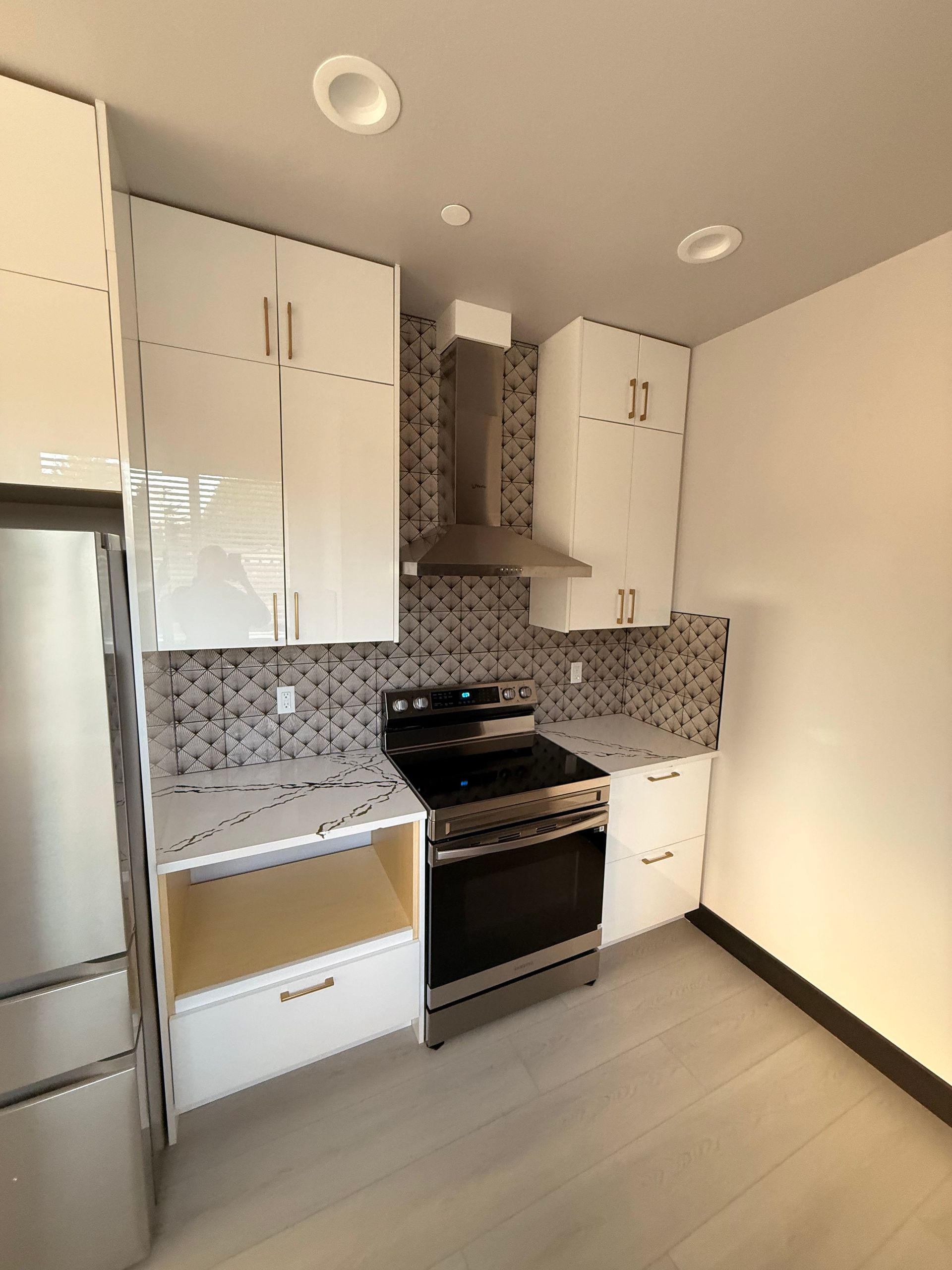 Construction worker in trench, installing drainage pipe. Dirt, plastic sheeting, and machinery visible. Cloudy day.