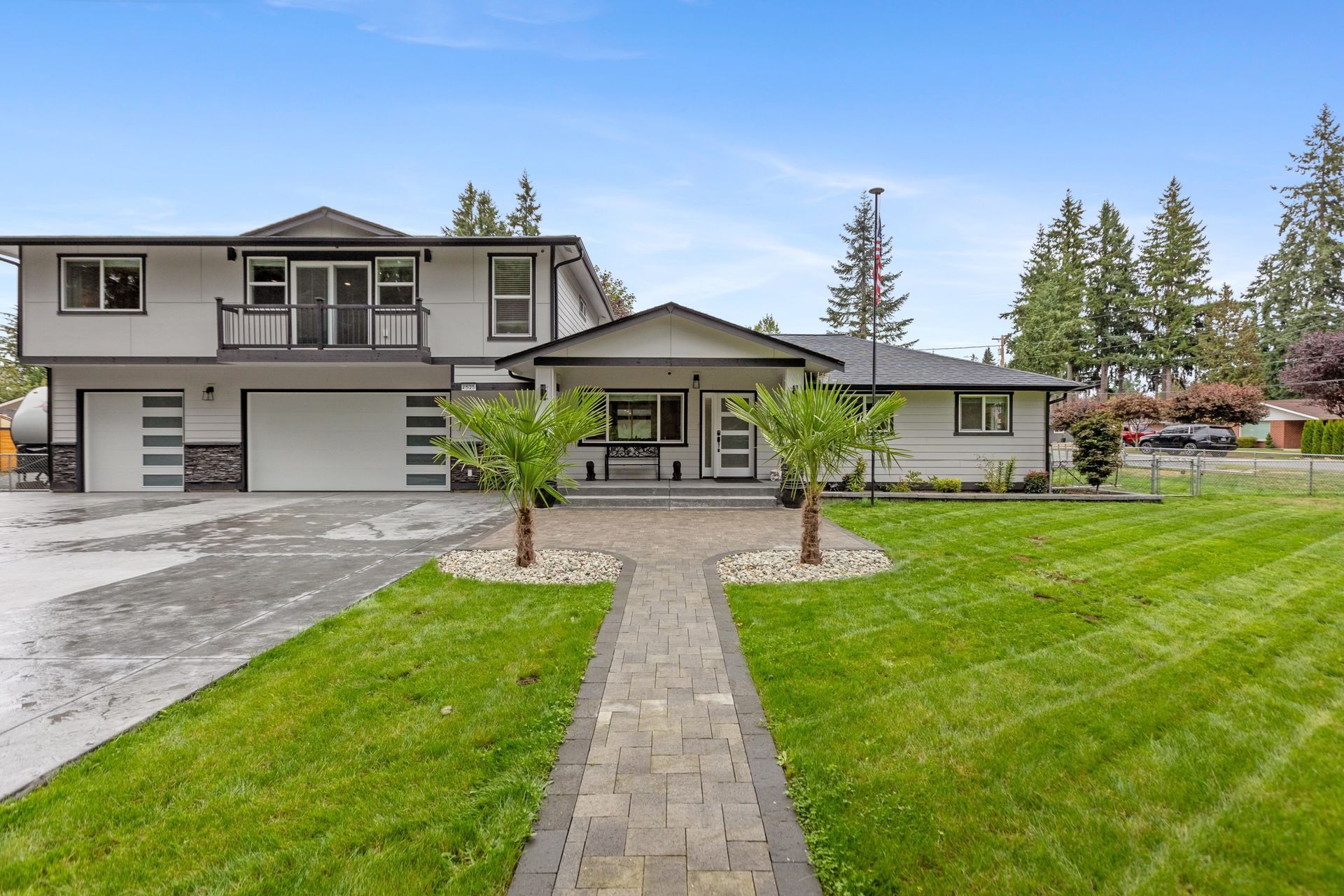 Construction worker in trench, installing drainage pipe. Dirt, plastic sheeting, and machinery visible. Cloudy day.
