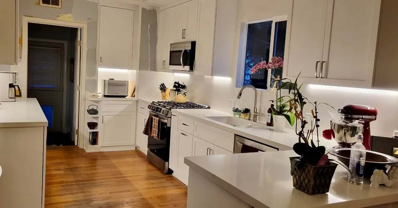 A kitchen with white cabinets and stainless steel appliances.