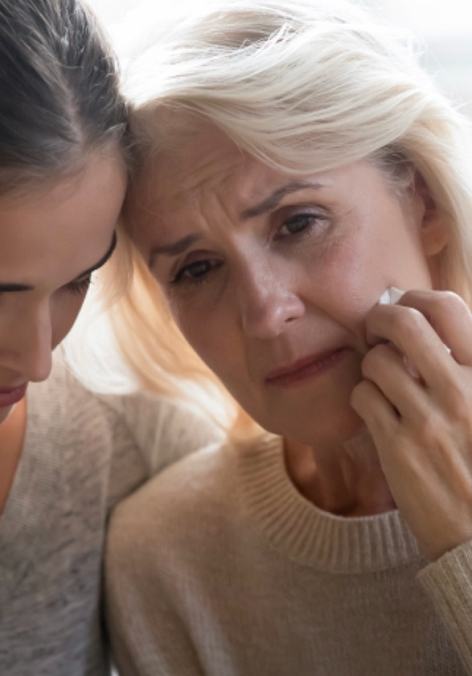 A woman is comforting an older woman who is crying.