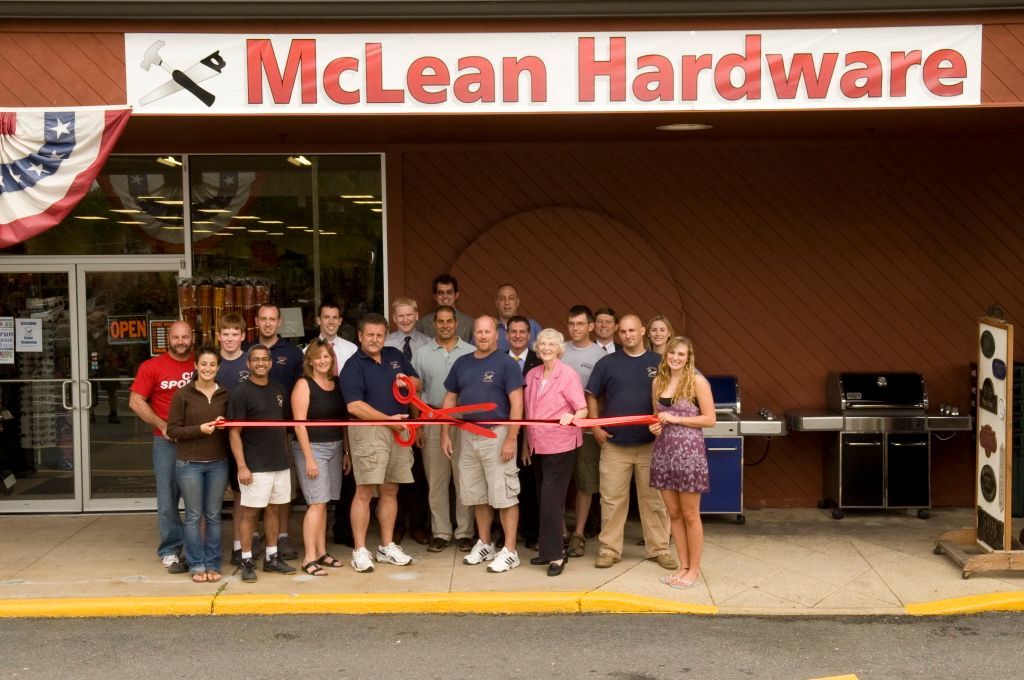 Hardware store employee working at a computer, surrounded by tools and supplies.