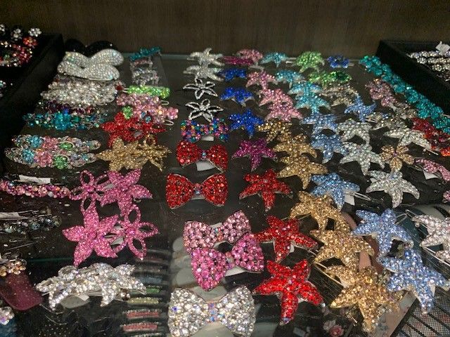 A Bunch Of Hair Clips Are Lined Up On A Table — Roseville, CA — Love Your Hair Wigs