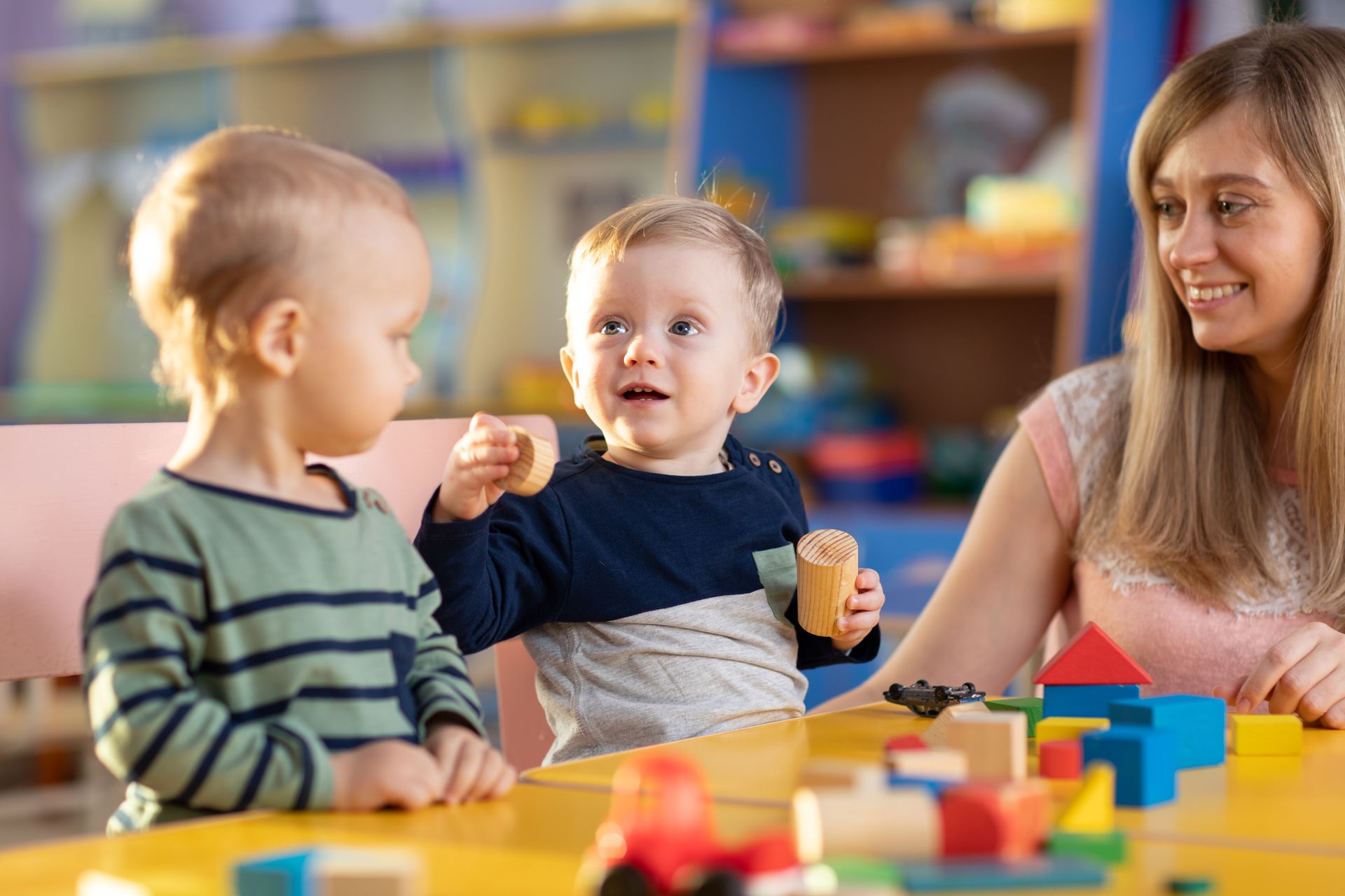 Kids playing with teacher in kindergarten. Kids playing with teacher in kindergarten.