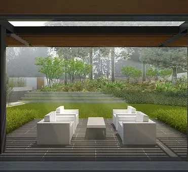 Outdoor seating area with white couches, table, and view of trees through a covered structure.