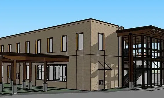 Tan, modern two-story building with tall, rectangular windows. Entry has a wooden portico, and a glass-enclosed section.