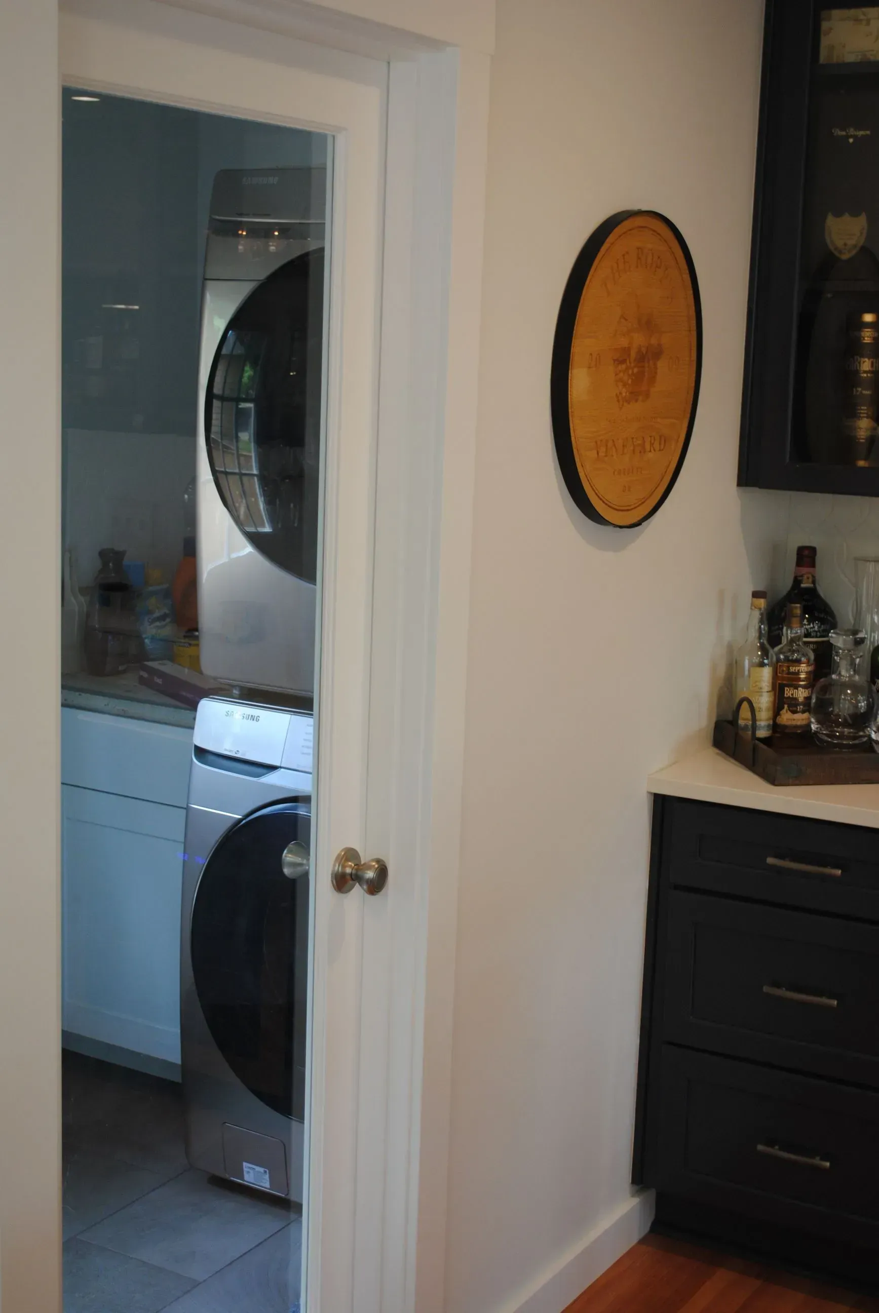 Open doorway to a laundry room with a washer and dryer; a decorative circle on the wall.