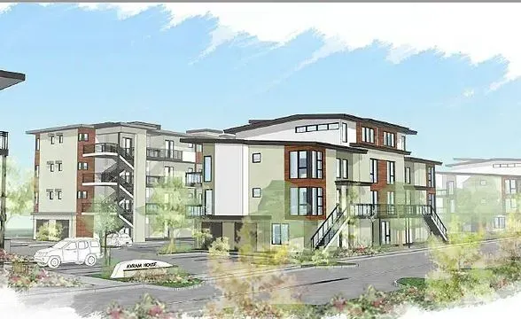 Rendering of modern multi-unit apartment complex with light-colored siding, balconies, and landscaping.