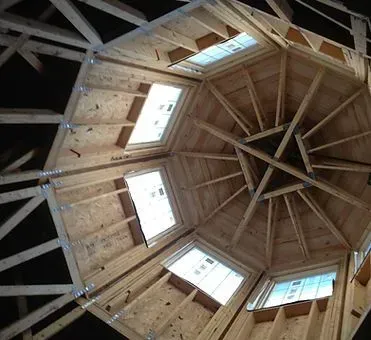 Wooden octagonal ceiling with skylights during construction.