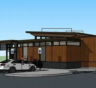 Modern building with parking spots, including charging stations for electric vehicles.