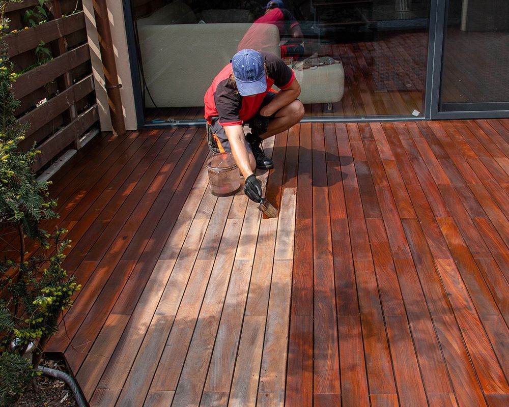 Worker Staining Wooder Deck Floor