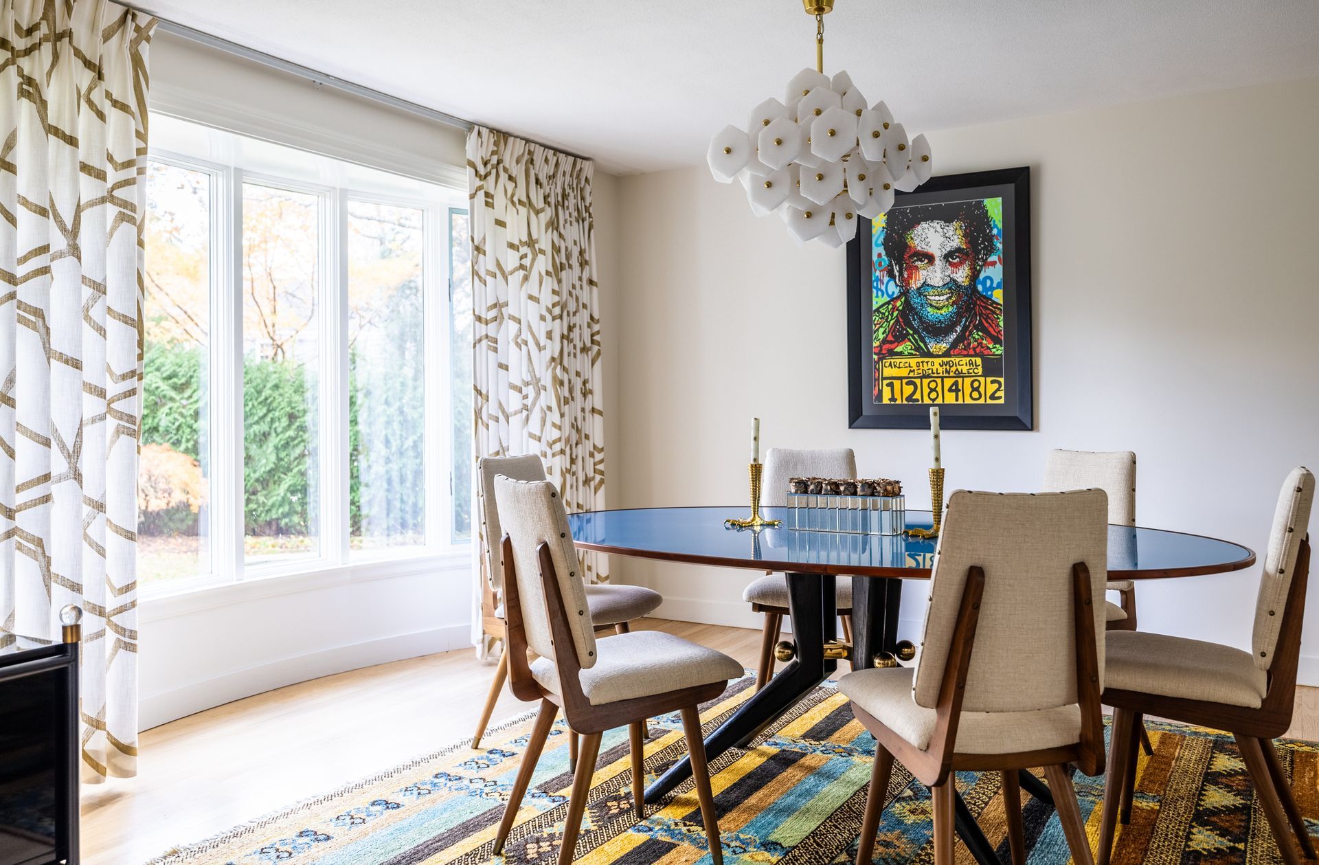 Bedroom with a large Johnny Cash mural, bed, and French doors with patterned shades.