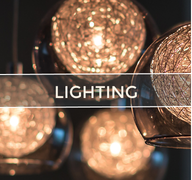 Close-up of decorative pendant lights with spherical woven shades glowing softly. Text overlay: LIGHTING.