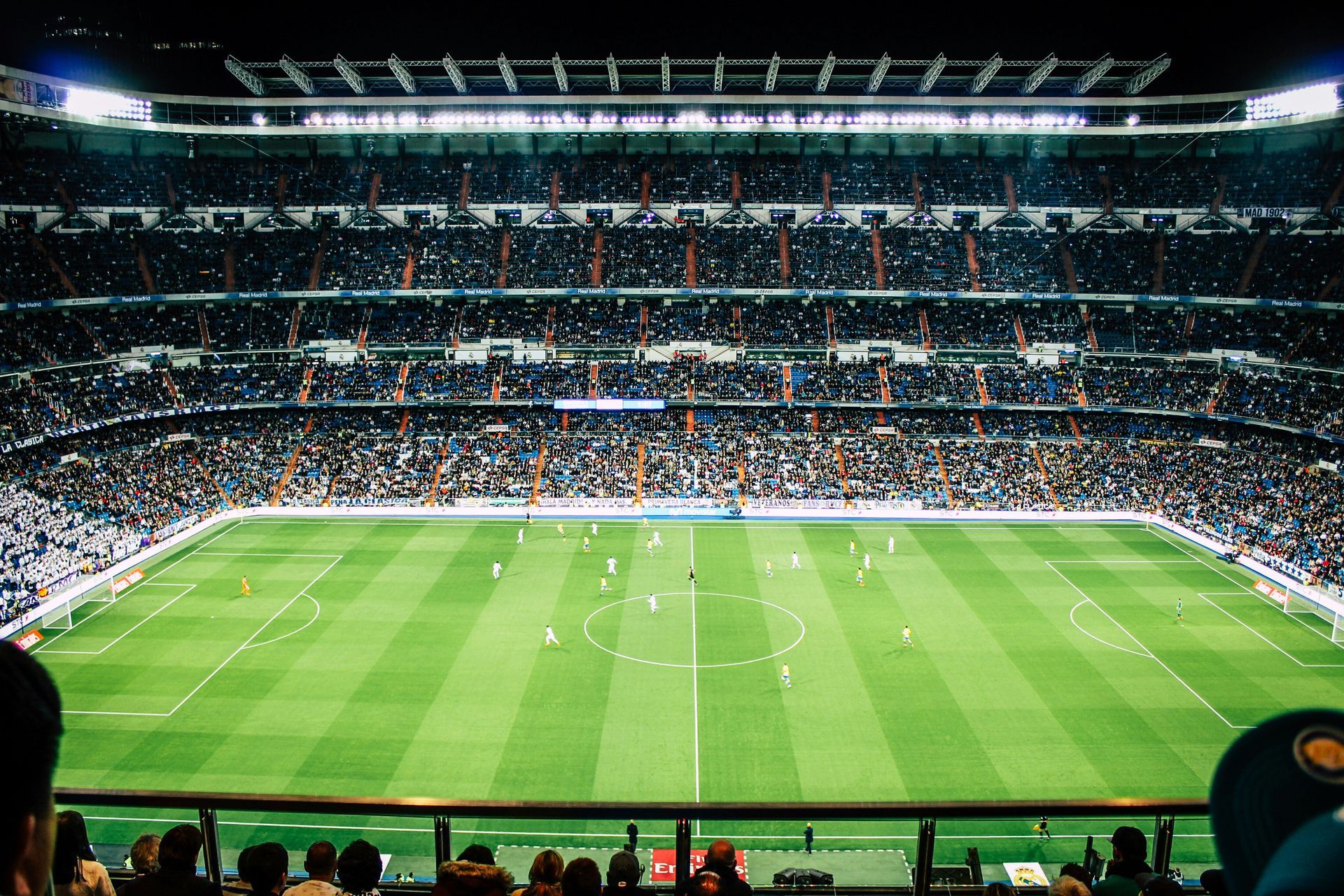 Big football stadium with fans watching the football game 