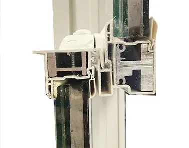 Cross-section of a white window frame with glass panels and a complex internal structure.
