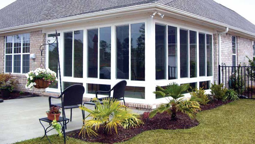 Enclosed Florida patio with new vinyl windows, lower transom, and a fiberglass exterior door.
