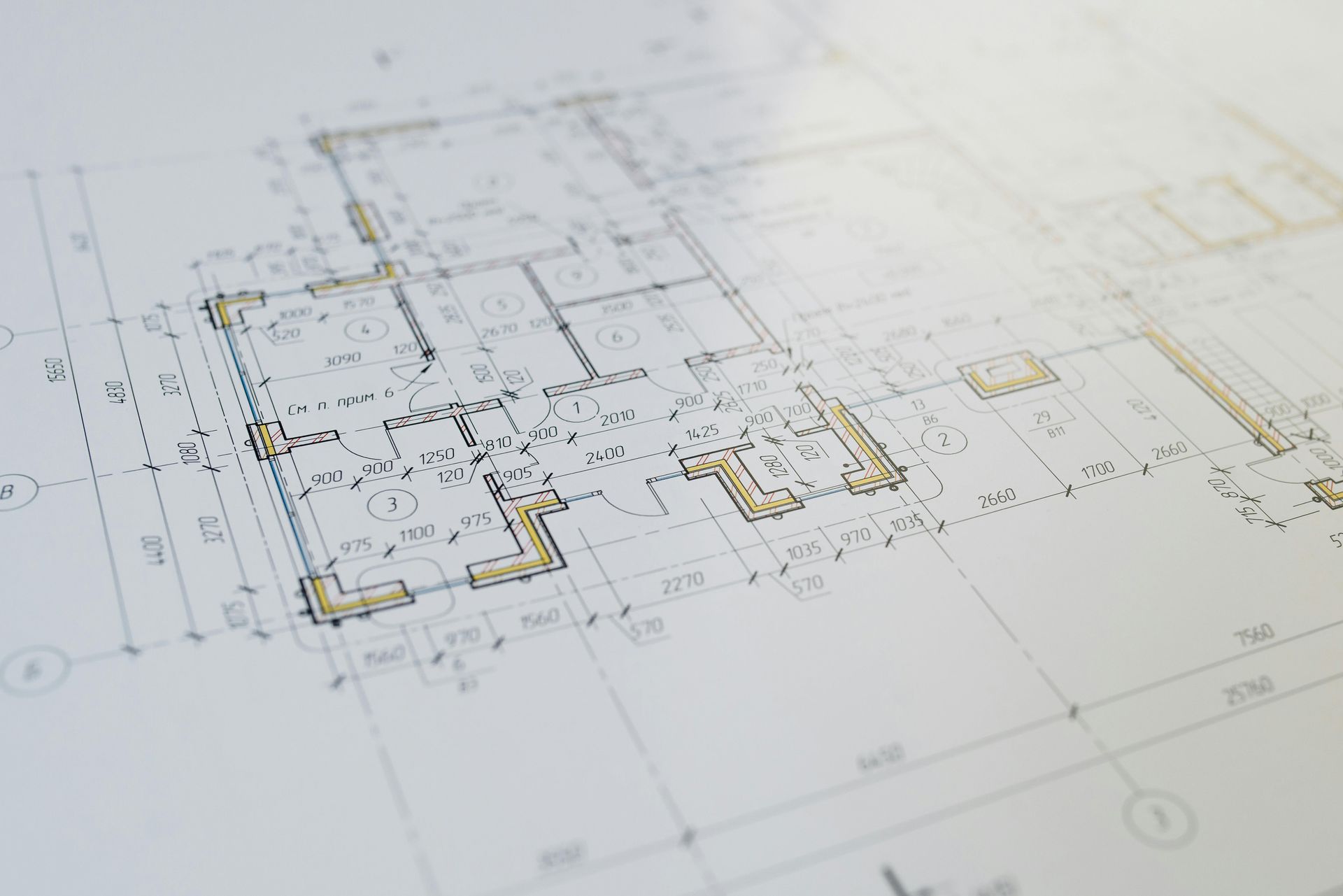 Architectural floor plan sketch on white paper with black and yellow markings