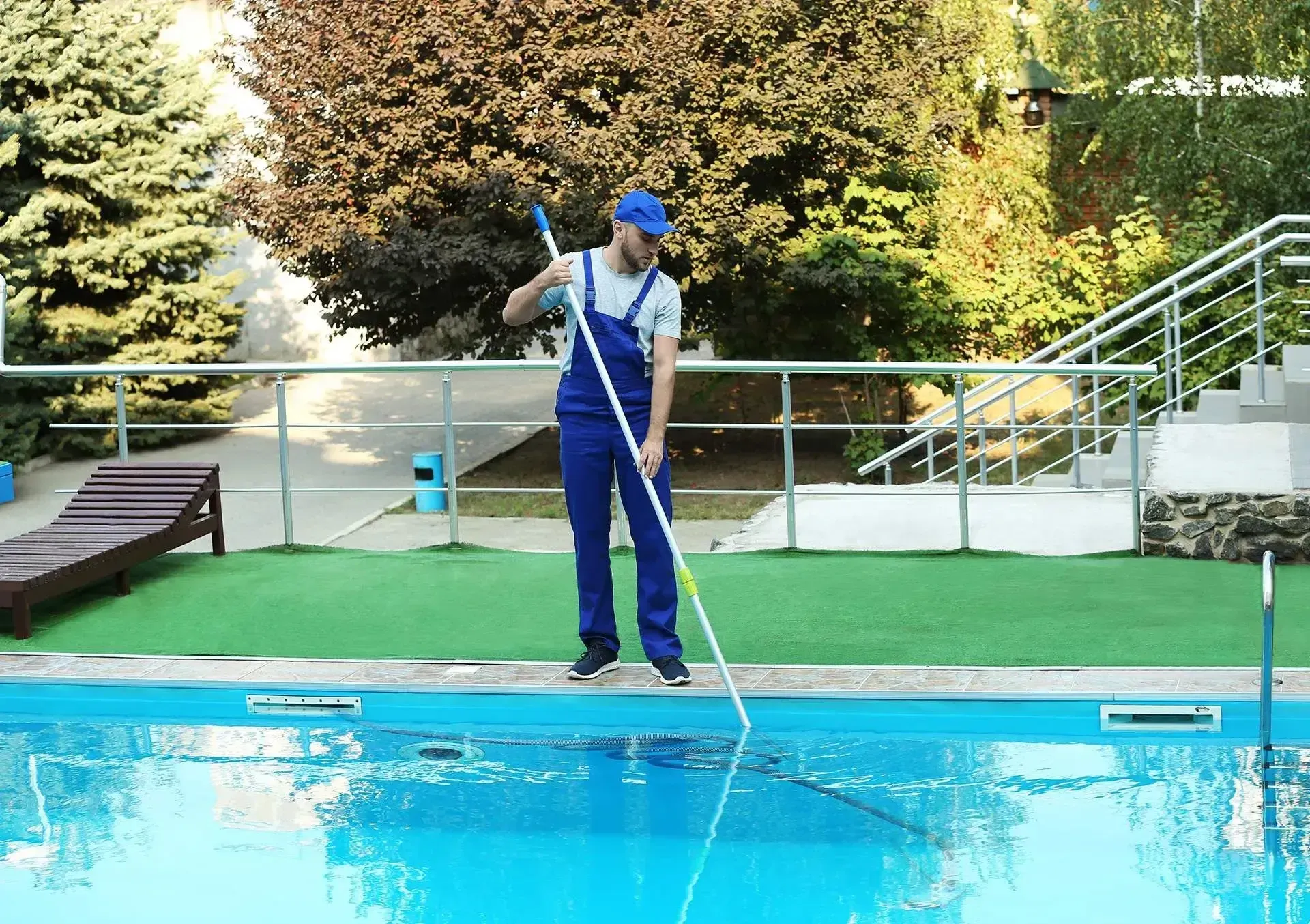 Pool technician cleaning pool