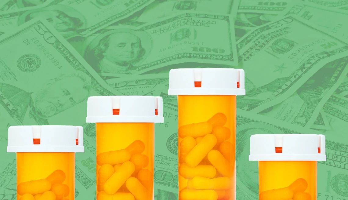 Four orange prescription pill bottles of varying heights against a background of overlapping U.S. hundred-dollar bills.