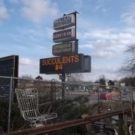 A sign for Ames Greenhouse featuring 