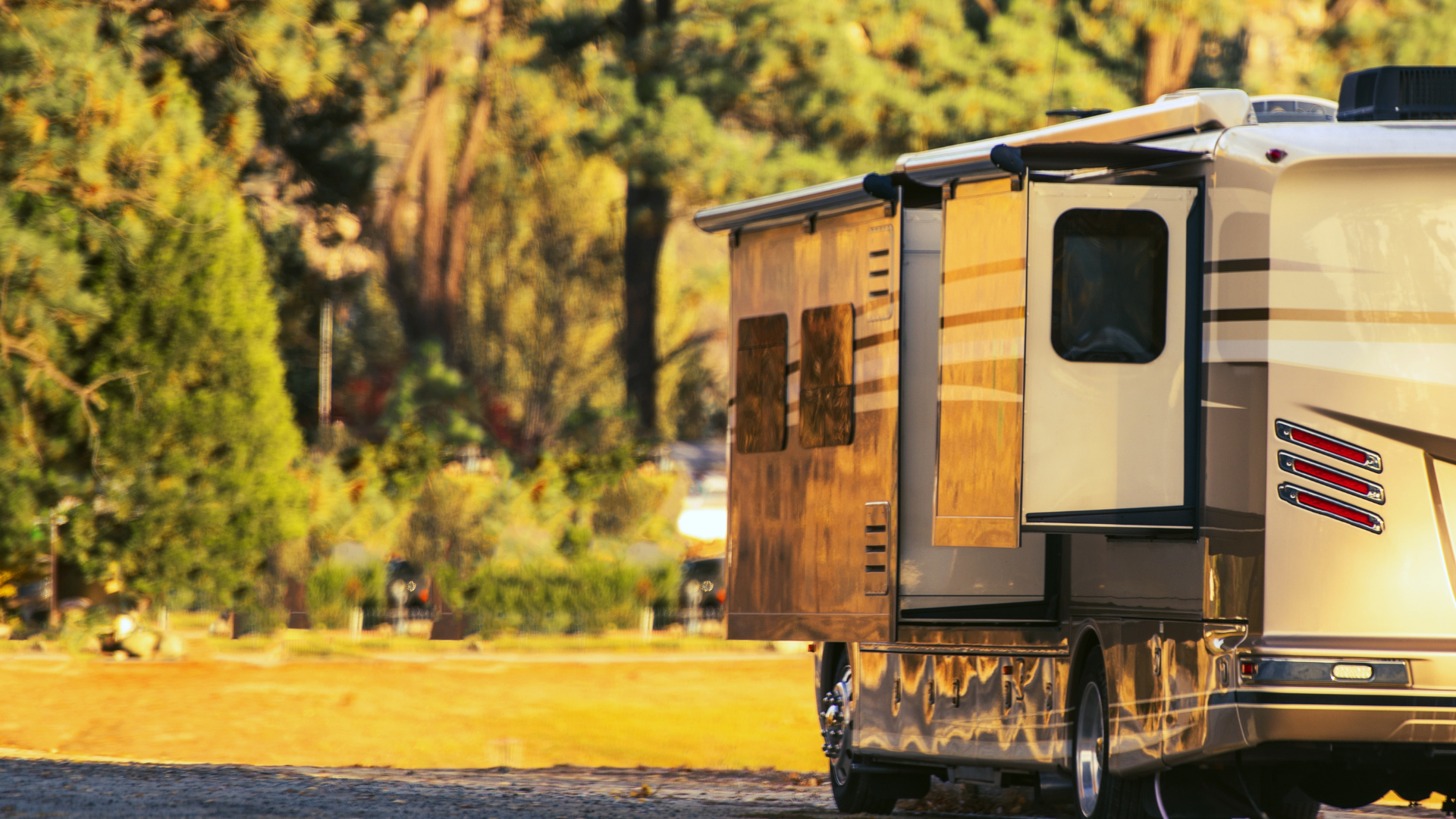 A rv is parked on the side of a dirt road.