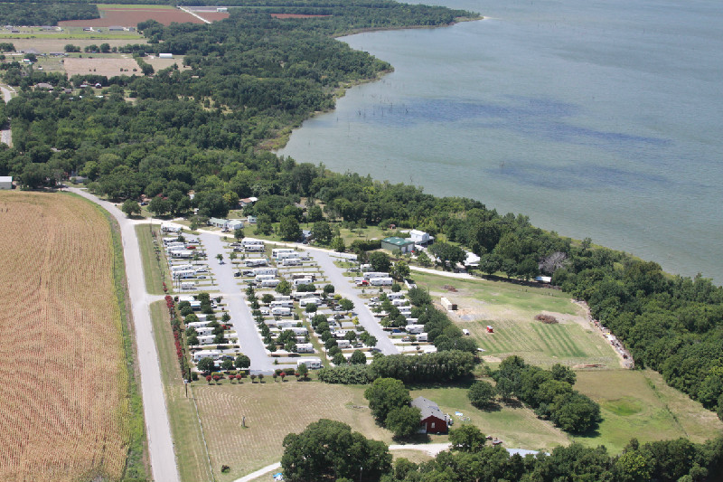 An aerial view of a campground on the shore of a lake