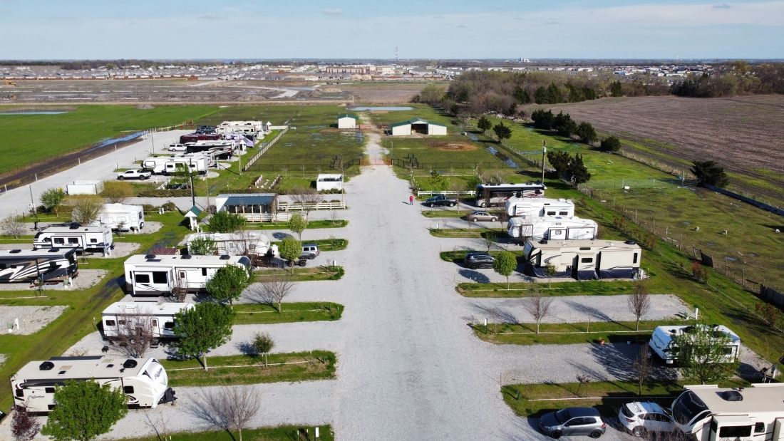 An aerial view of a rv park with a lot of rvs parked in the lot.