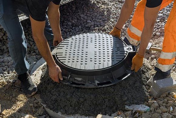 Worker Installs a Sewer Manhole on Septic Tank — Anderson, SC — A&R Septic Tank Cleaning