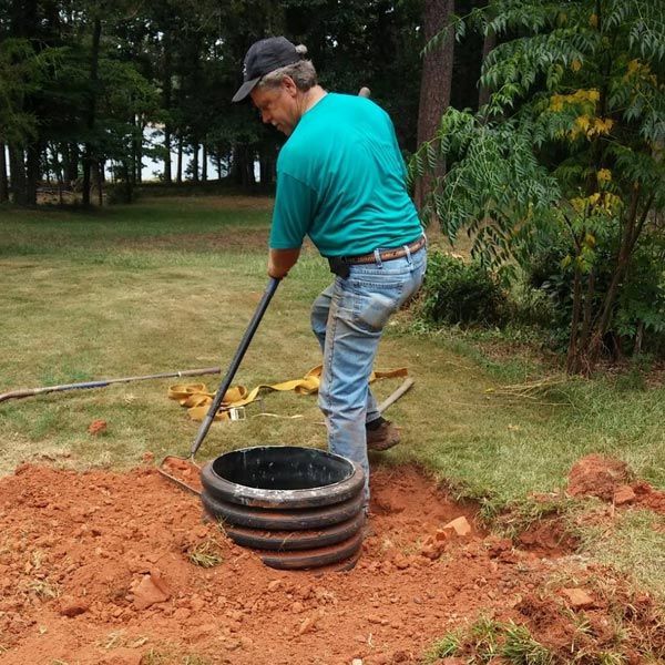 Man Installing Septic Tank — Anderson, SC — A&R Septic Tank Cleaning