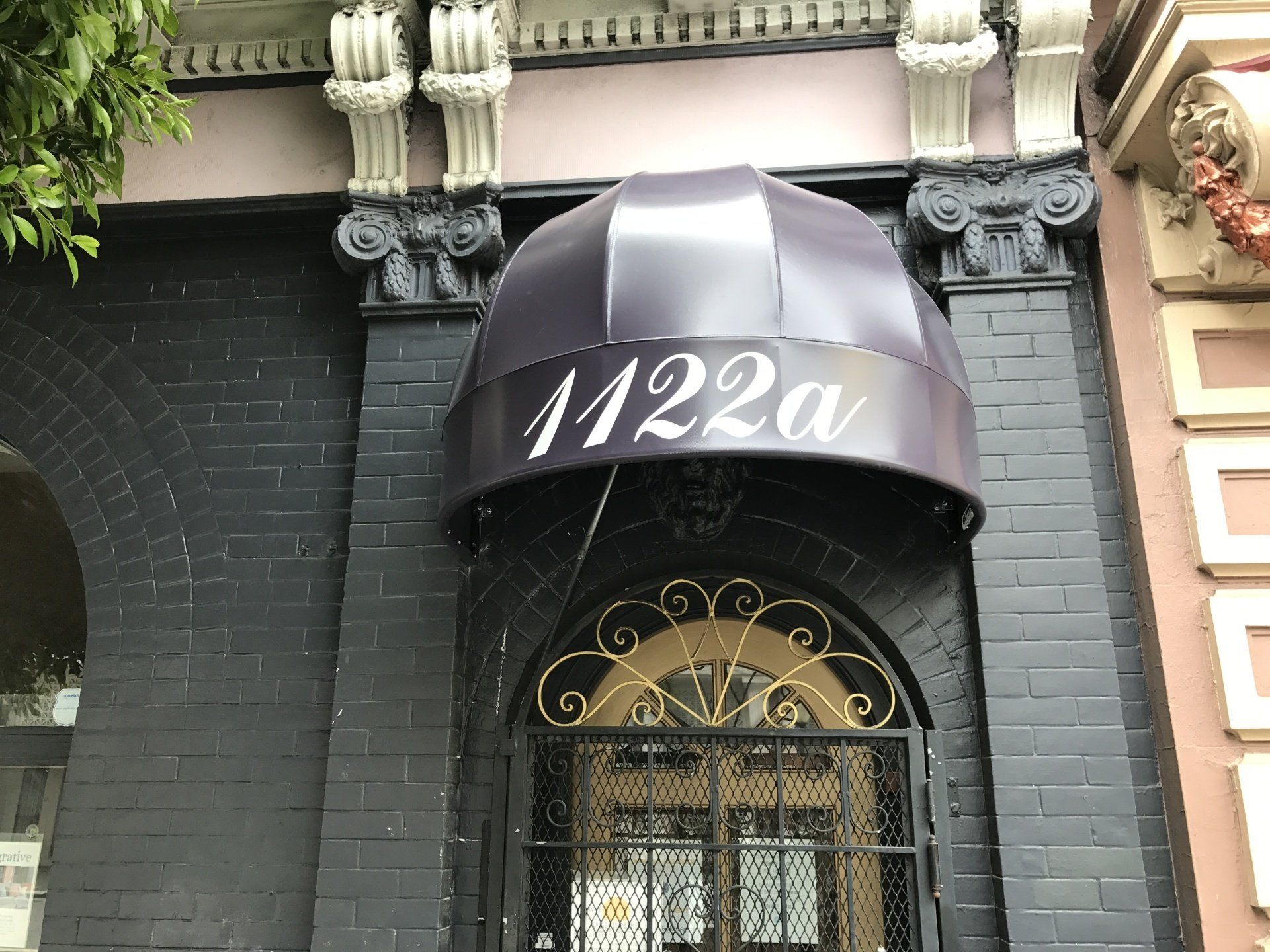 A building with a purple awning that says 1222 on it