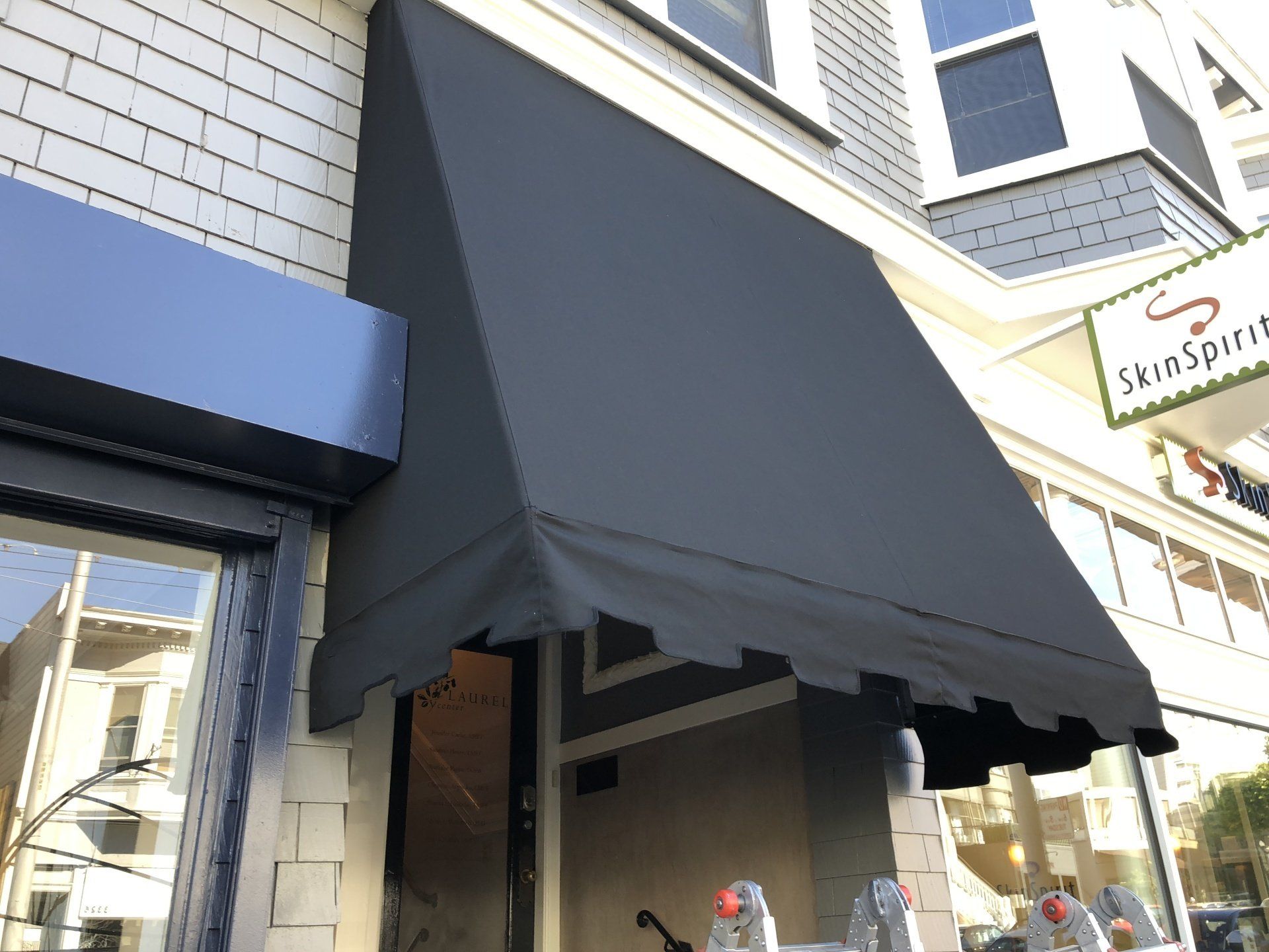A black awning is on the side of a building