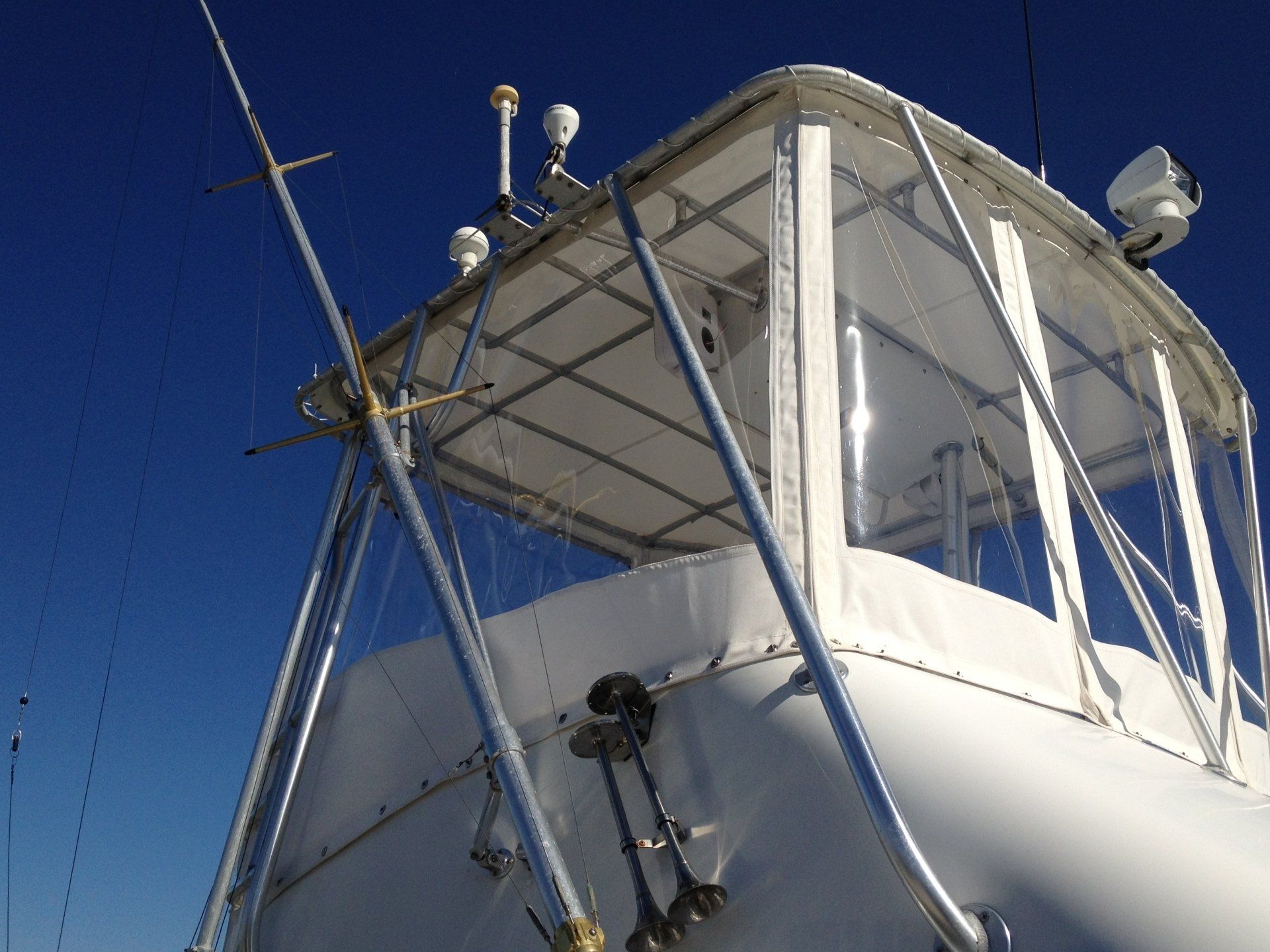 A white boat with a clear canopy on top of it