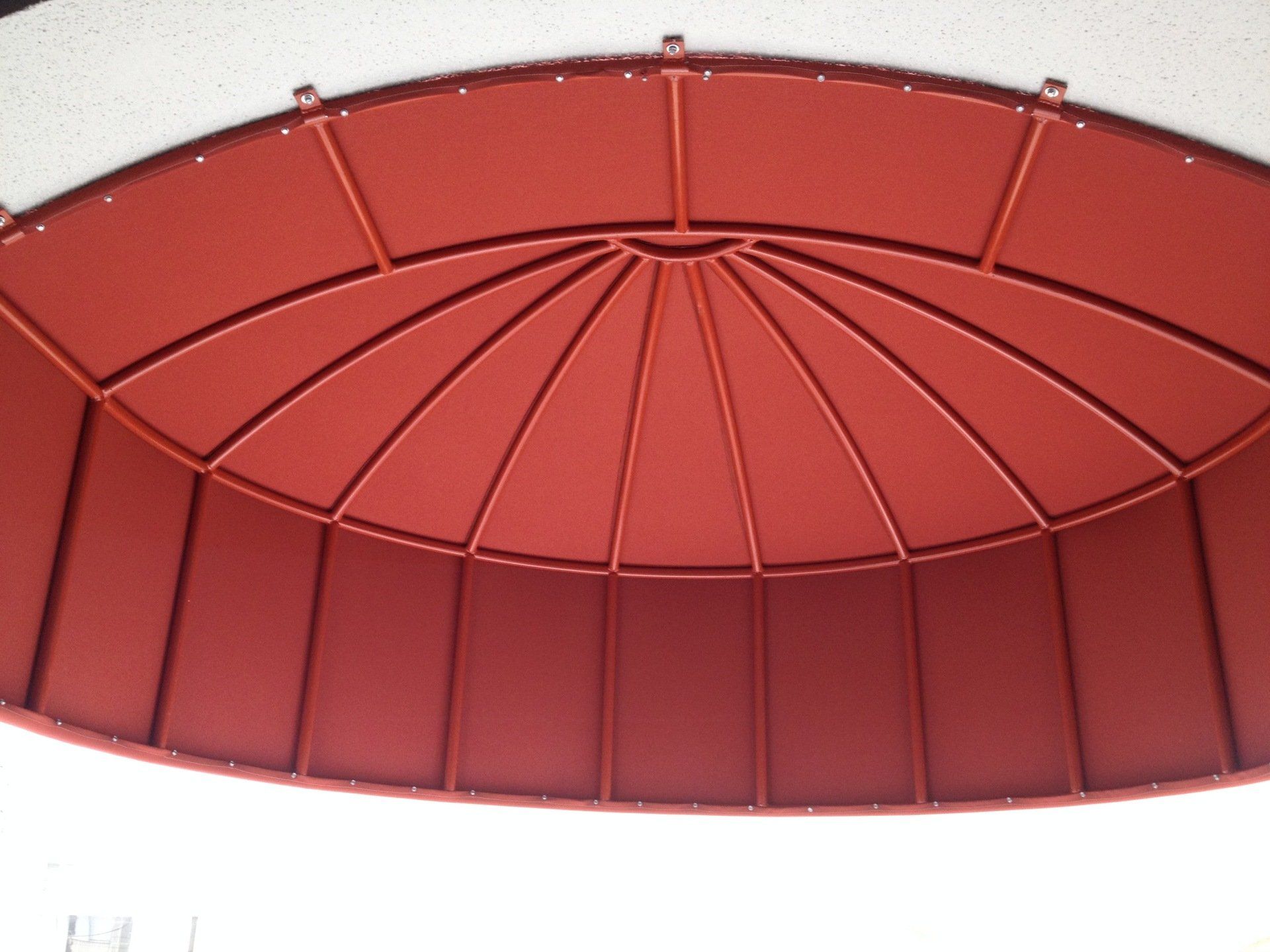 A red ceiling with a circular design on it