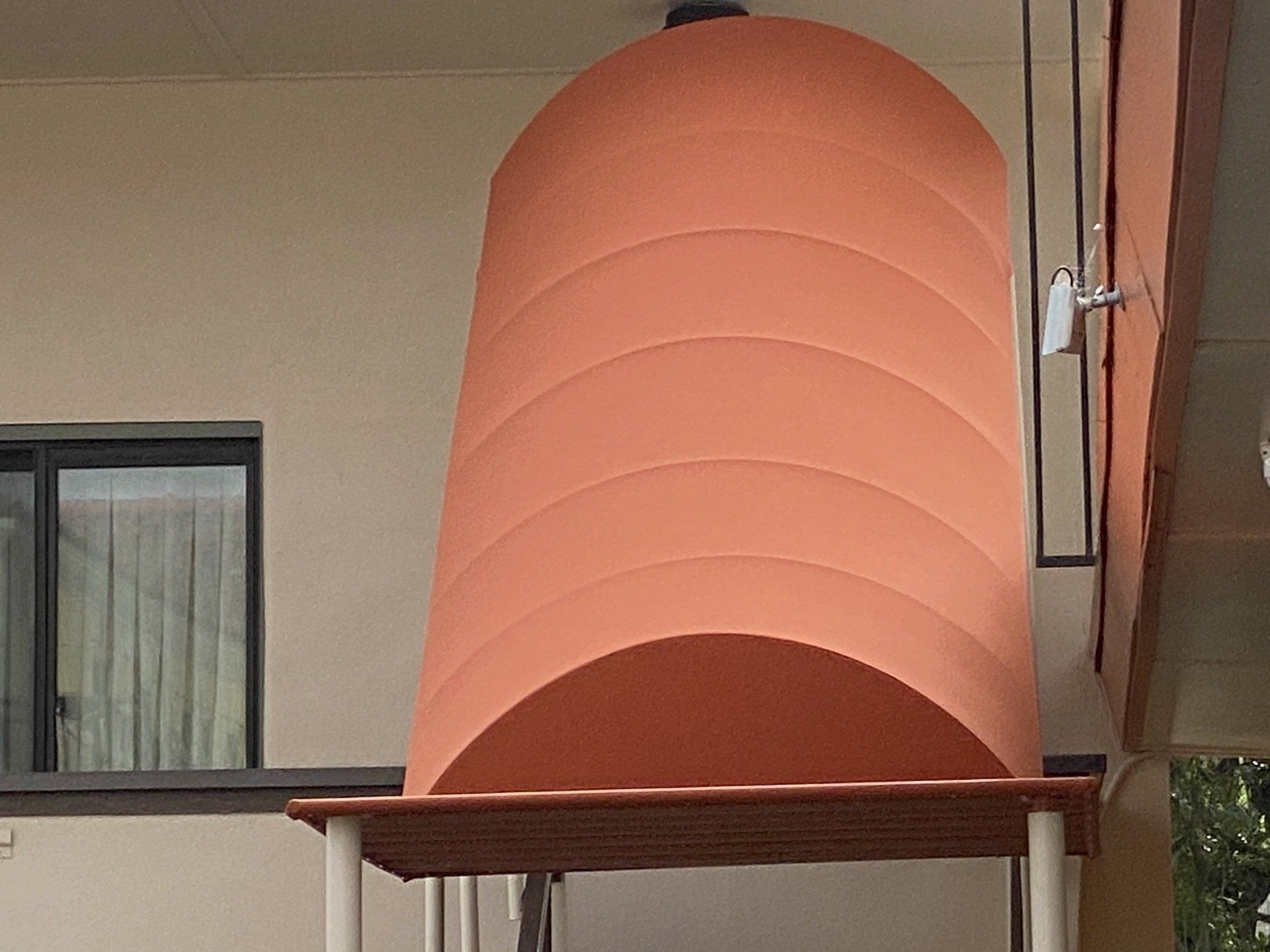 A large orange awning is on the side of a building