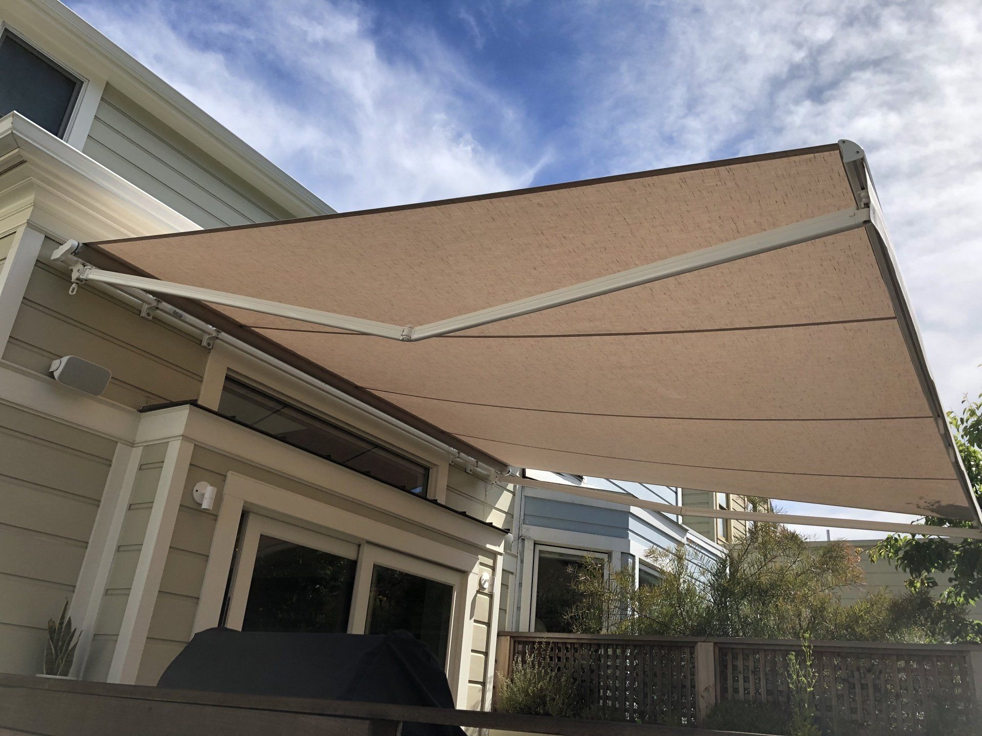 A large awning is sitting on the side of a house.