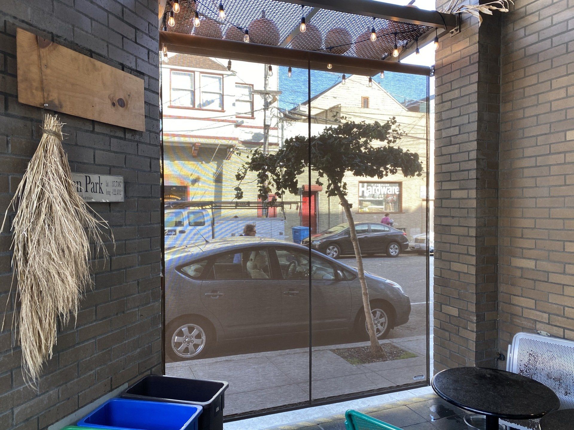 A car is parked in front of a glass door.
