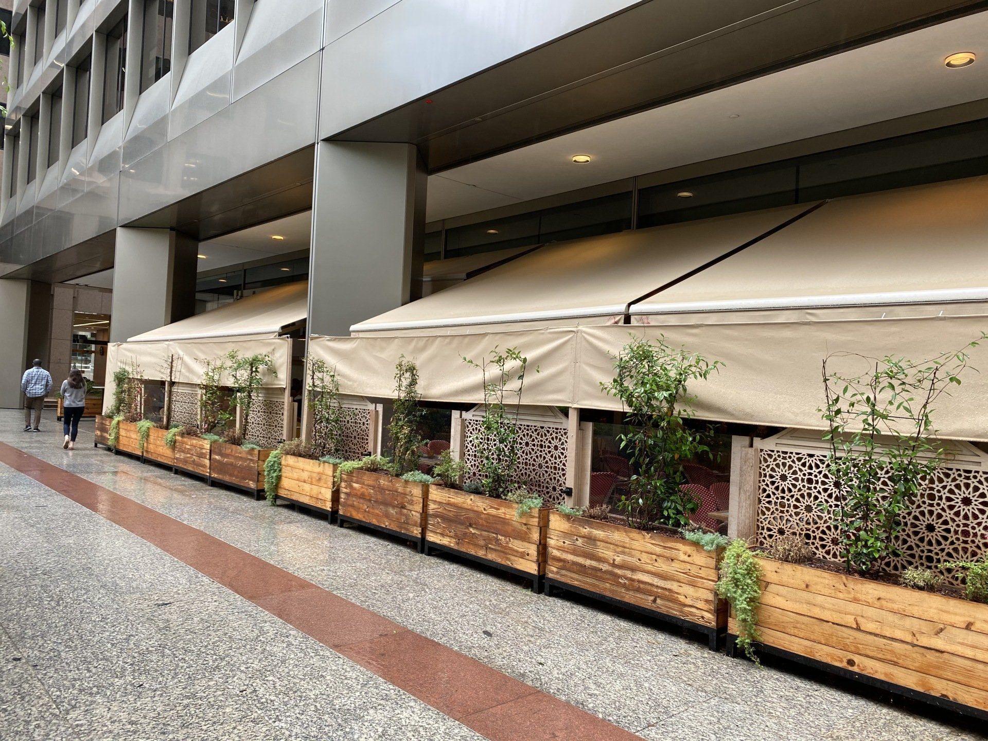 A building with a row of wooden planters in front of it.