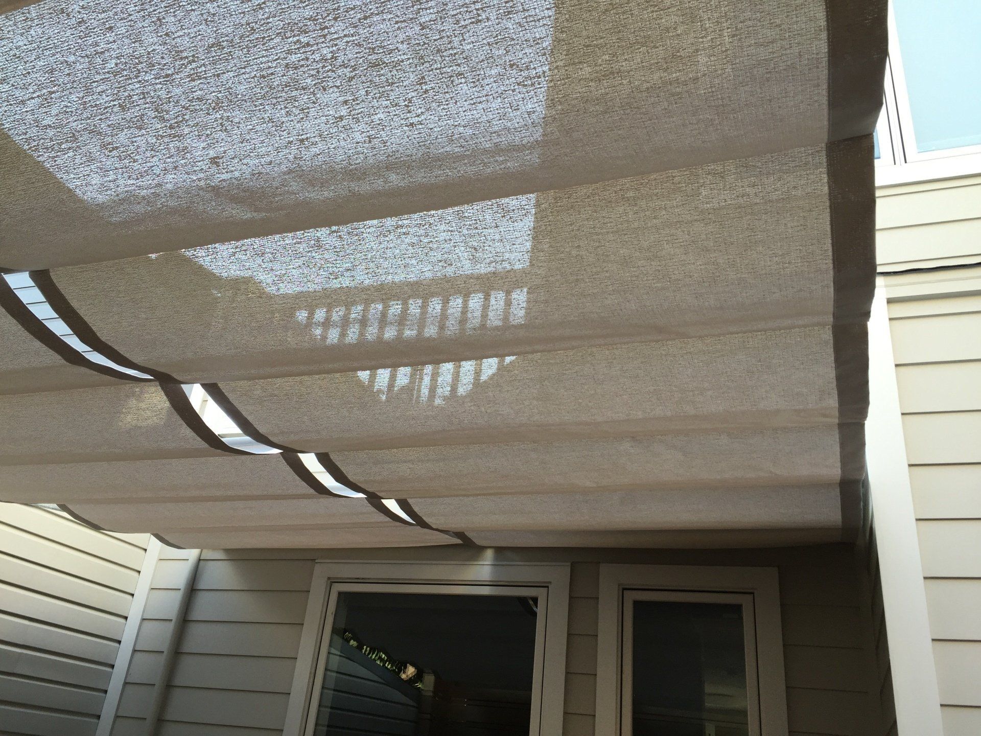 A white house with a shade covering the windows