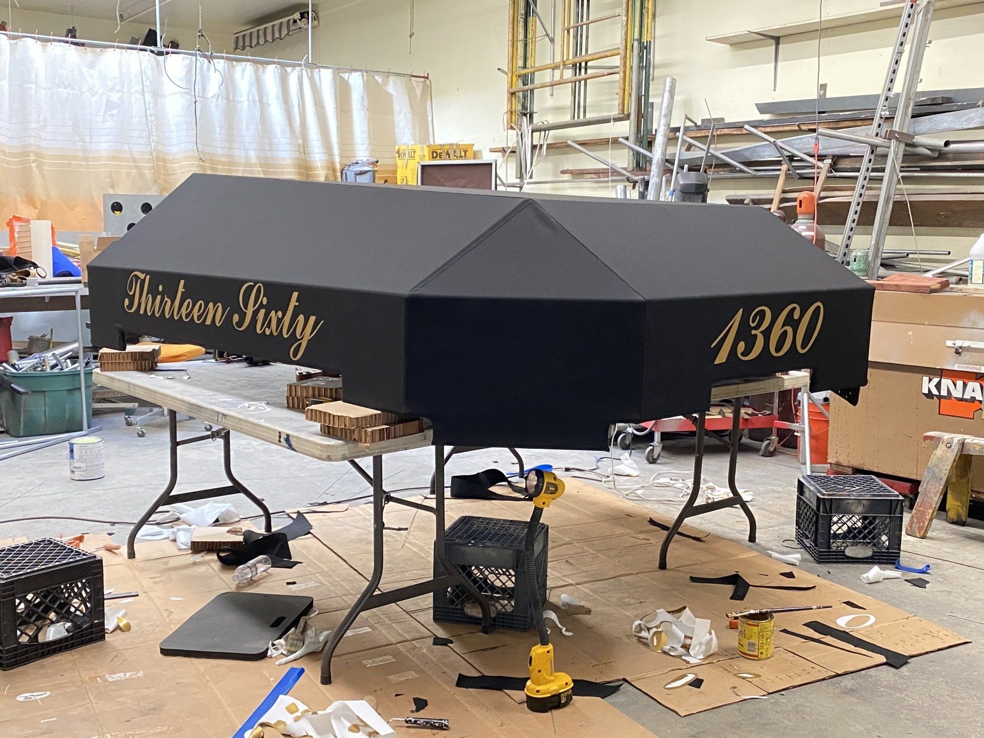 A black umbrella with the number 1360 on it