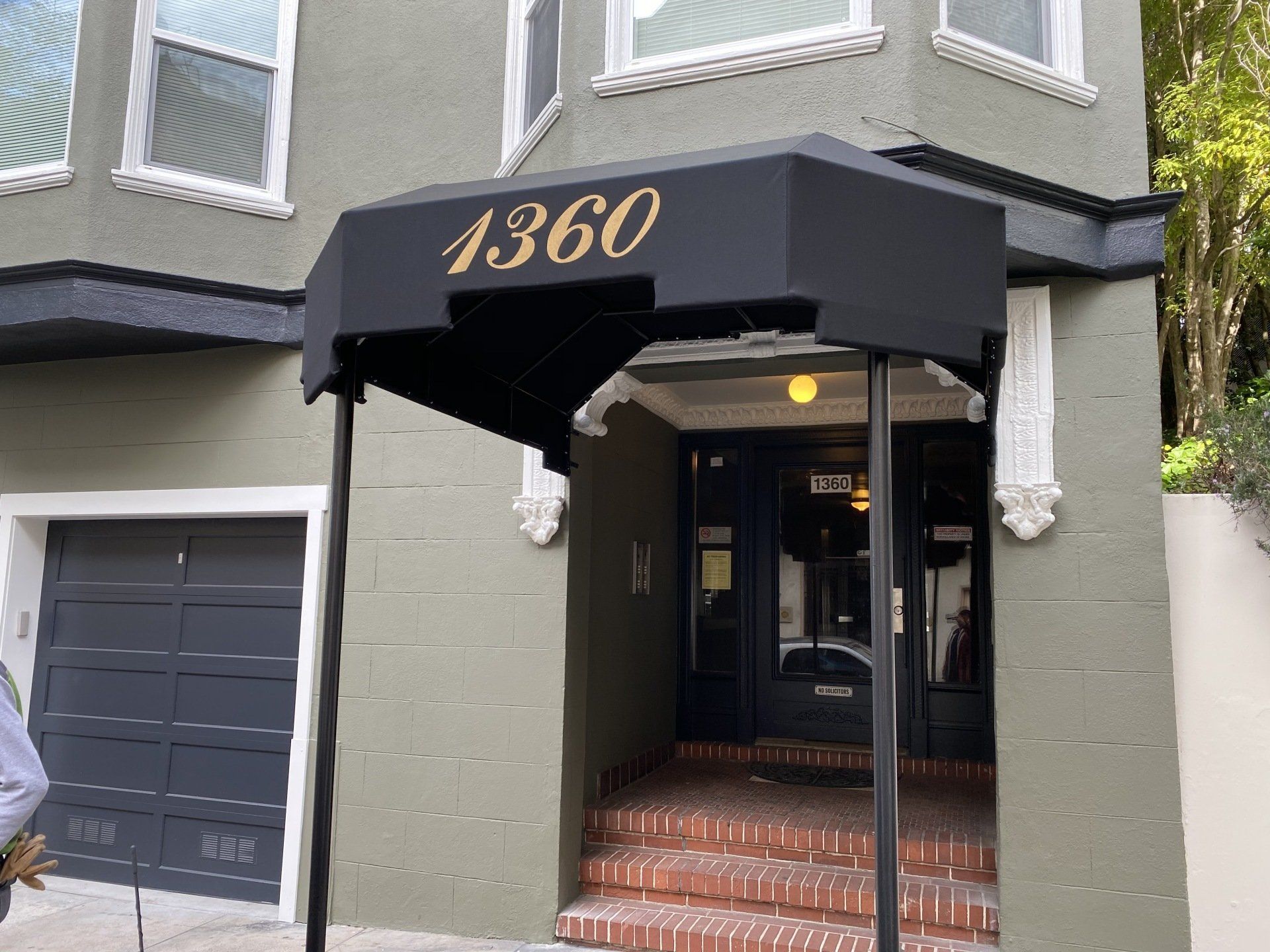 A building with a black awning that says 1360 on it